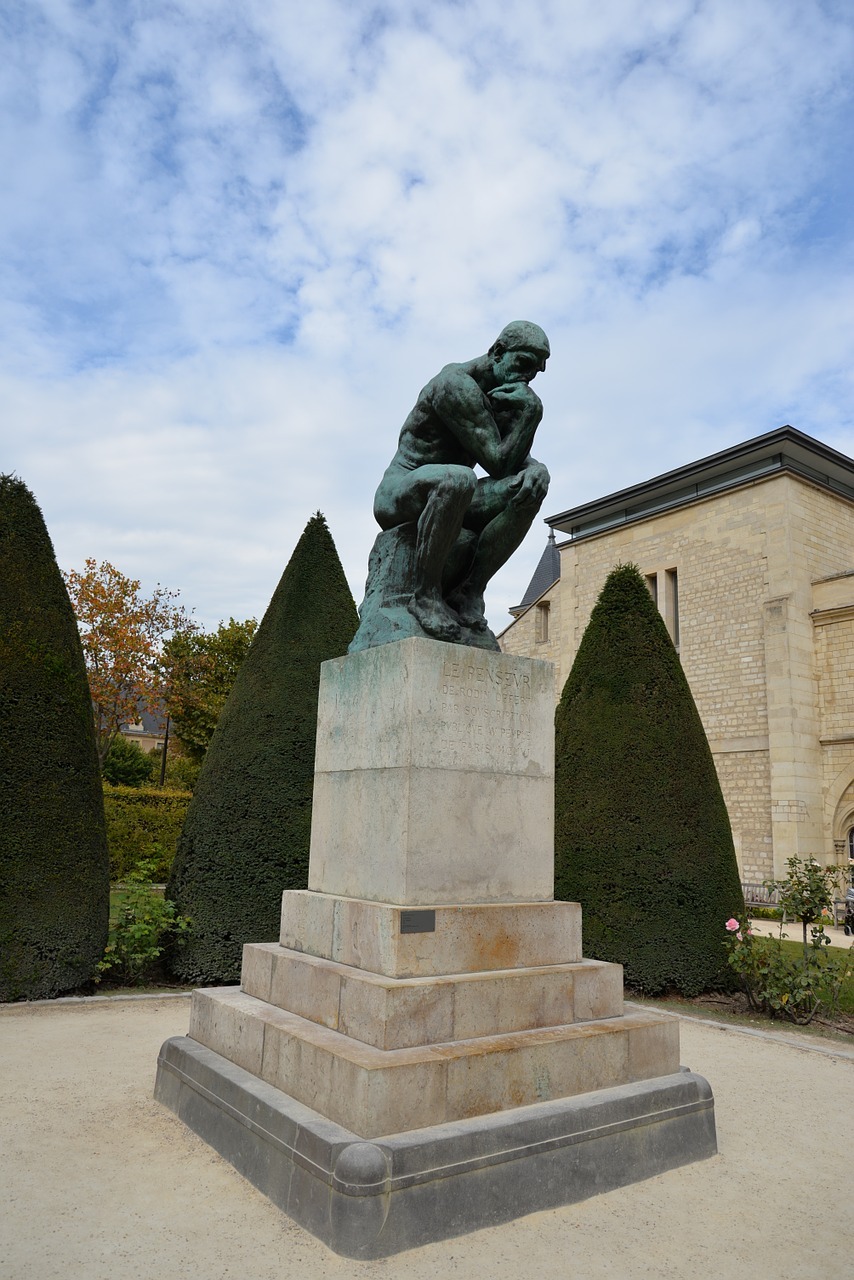 The Thinker statue on its stone pedestal